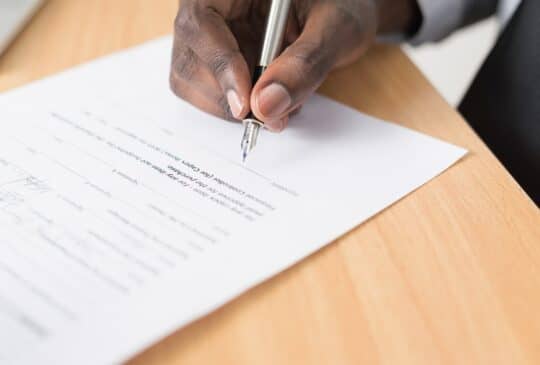 man signing an insurance contract